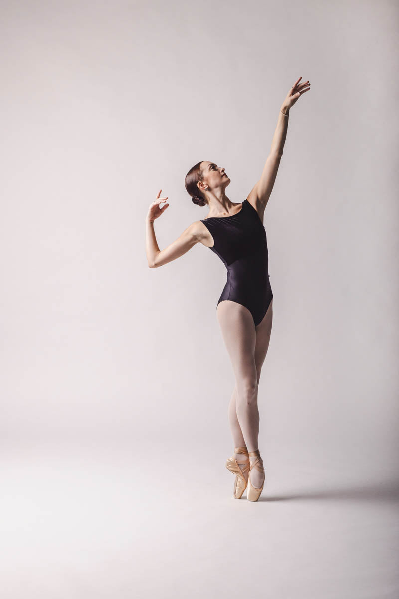 Claire Leotard, Color: Black Features a sleek and contouring design, a velour bust panel and boat neck, V-back and a tank silhouette. By worldwide Ballet full front view