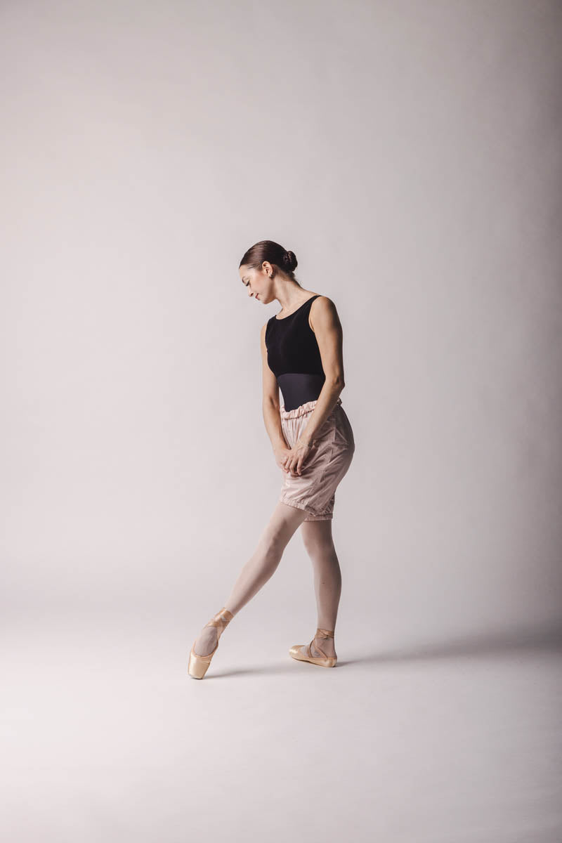 The dancer is wearing shorts trashbag pants in light pink, by worldwide ballet