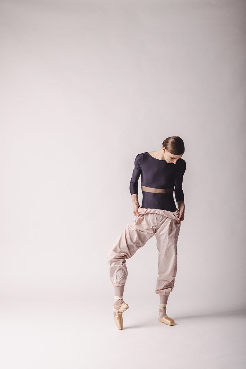 Elle is wearing light pink Trashbag Pants, perfect warm up pants, By worldwide Ballet
