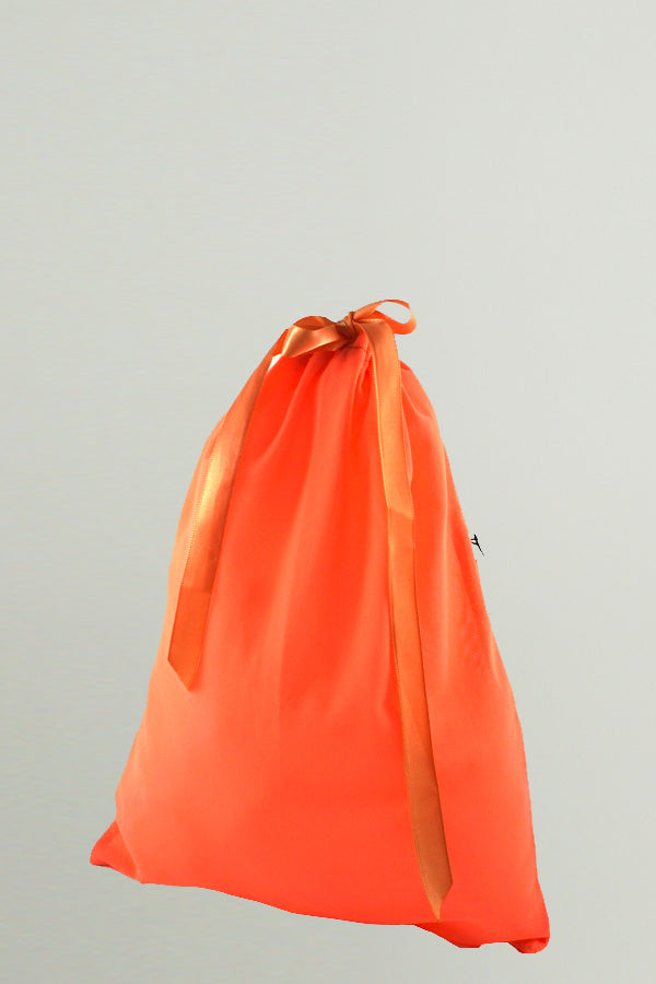 An Orange small bag made of mesh fabric with a matching satin ribbon closure, By worldwide Ballet.