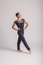 The dancer is wearing overall in dark grey, by worldwide Ballet