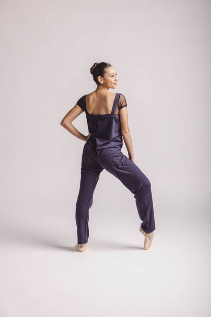 The dancer is wearing overall in dark grey, by worldwide Ballet