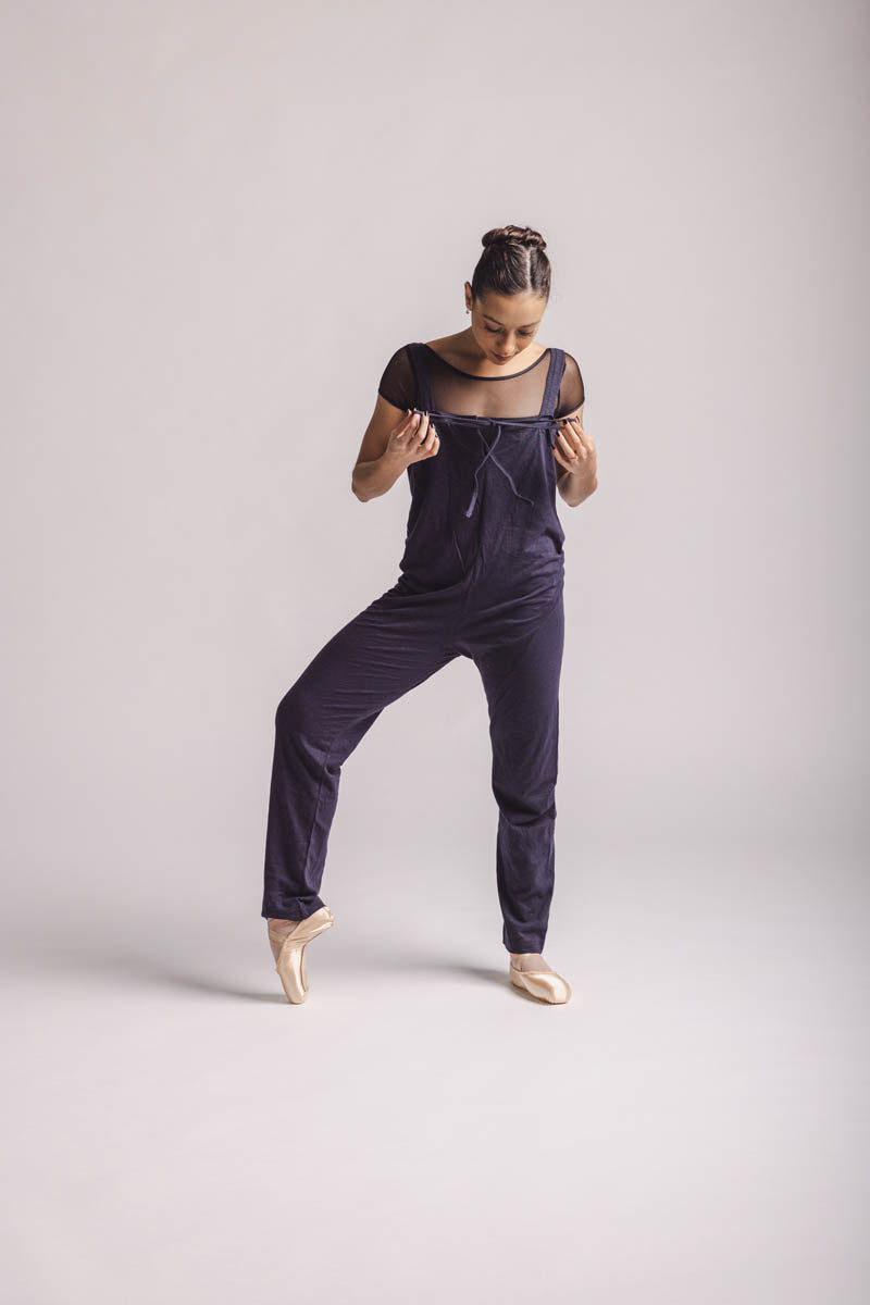 The dancer is wearing overall in dark grey, by worldwide Ballet