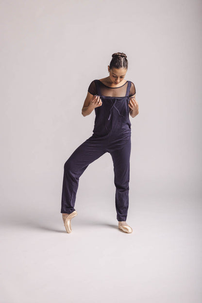 The dancer is wearing overall in dark grey, by worldwide Ballet