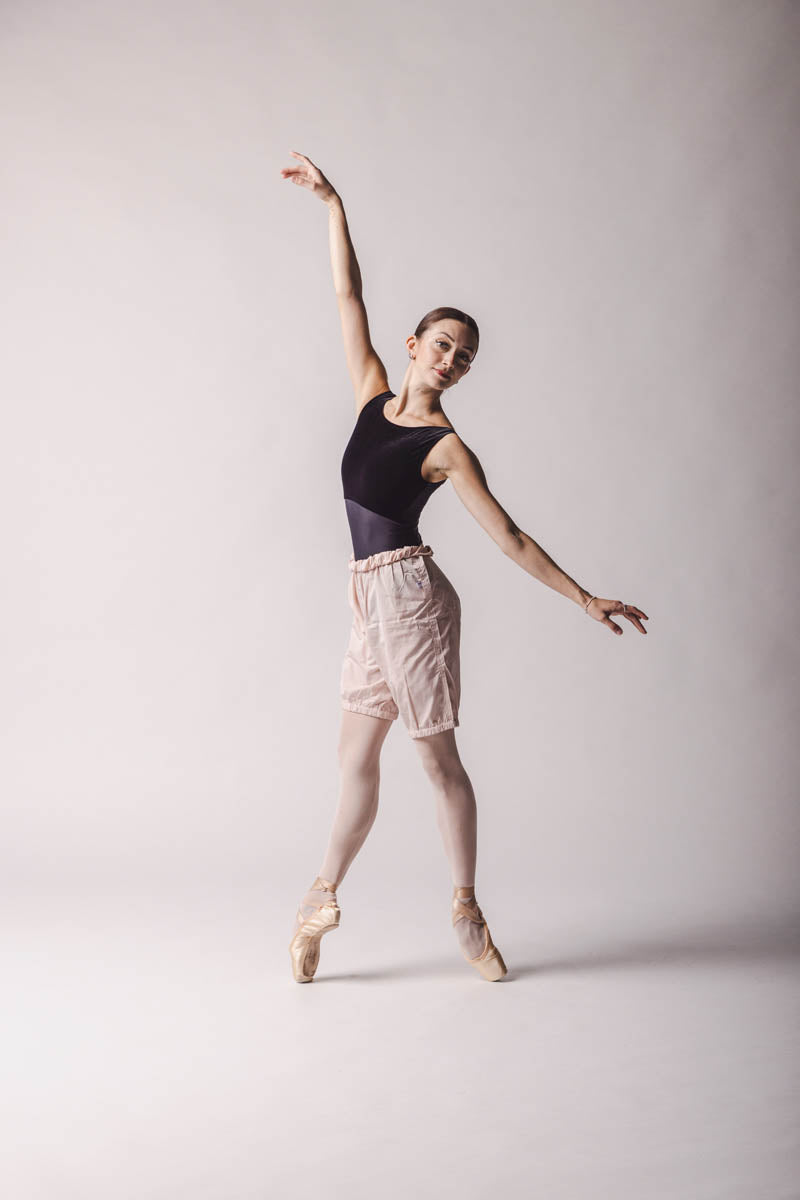 The dancer is wearing shorts trashbag pants in light pink, by worldwide ballet