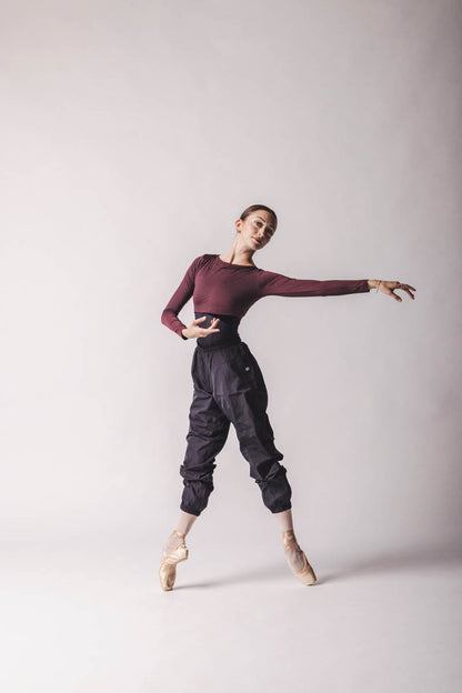 The dancer is wearing Crop Top color: Burgundy By worldwide Ballet