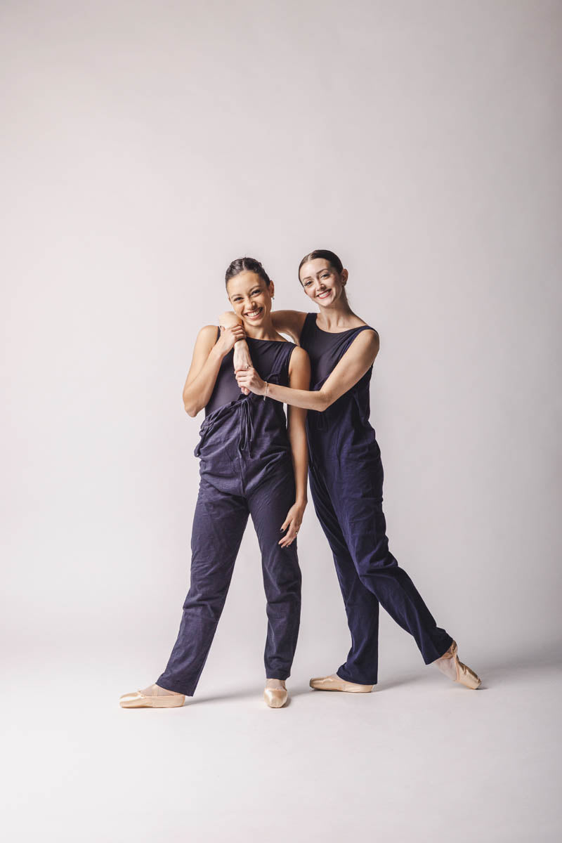 The dancers are wearing overall, on the right dark grey overall, on the left, dark blue overall, by worldwide ballet